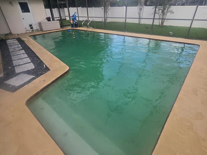 A green pool in a screened enclosure before recovery treatment